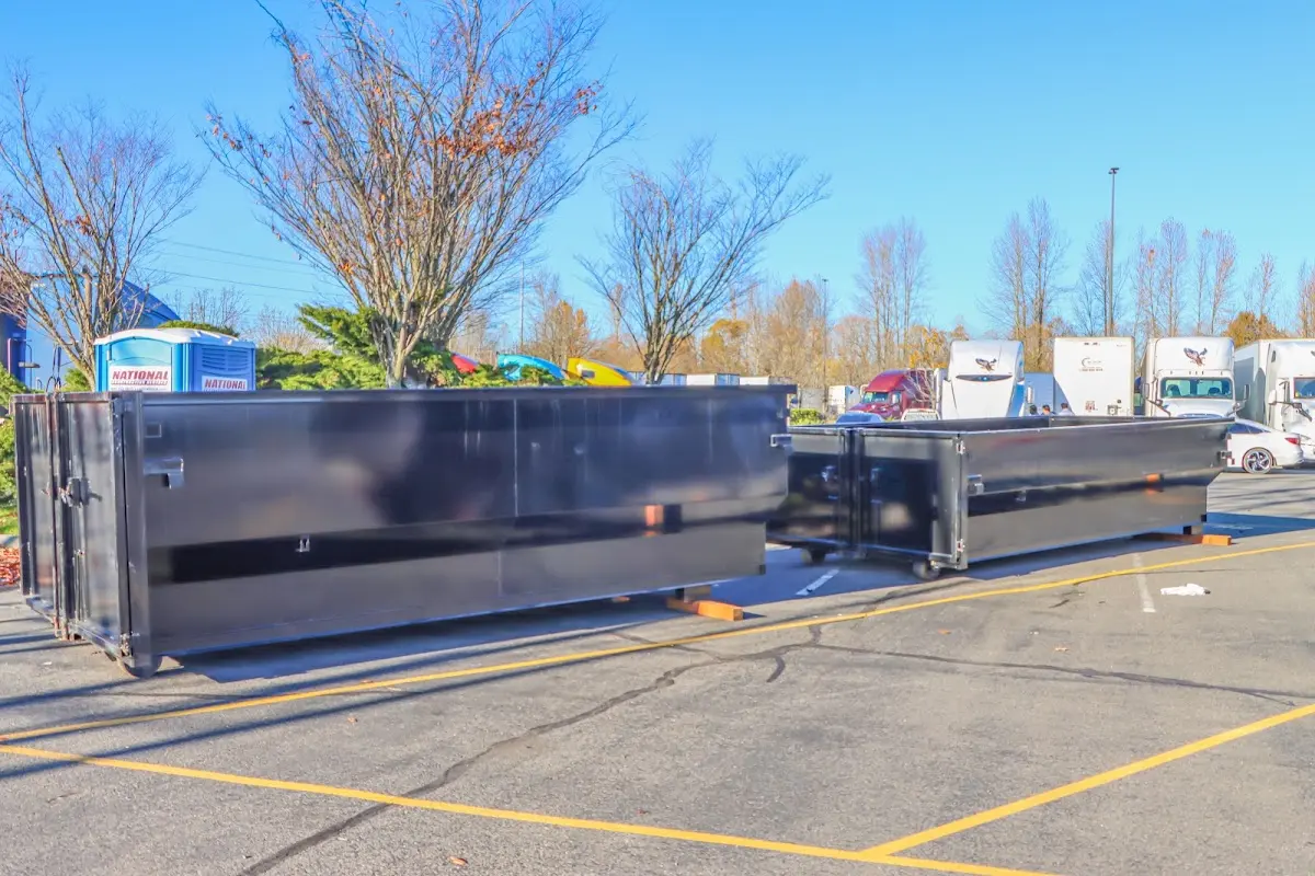 Professional dumpster rental service with roll-off container on residential driveway in DeRidder